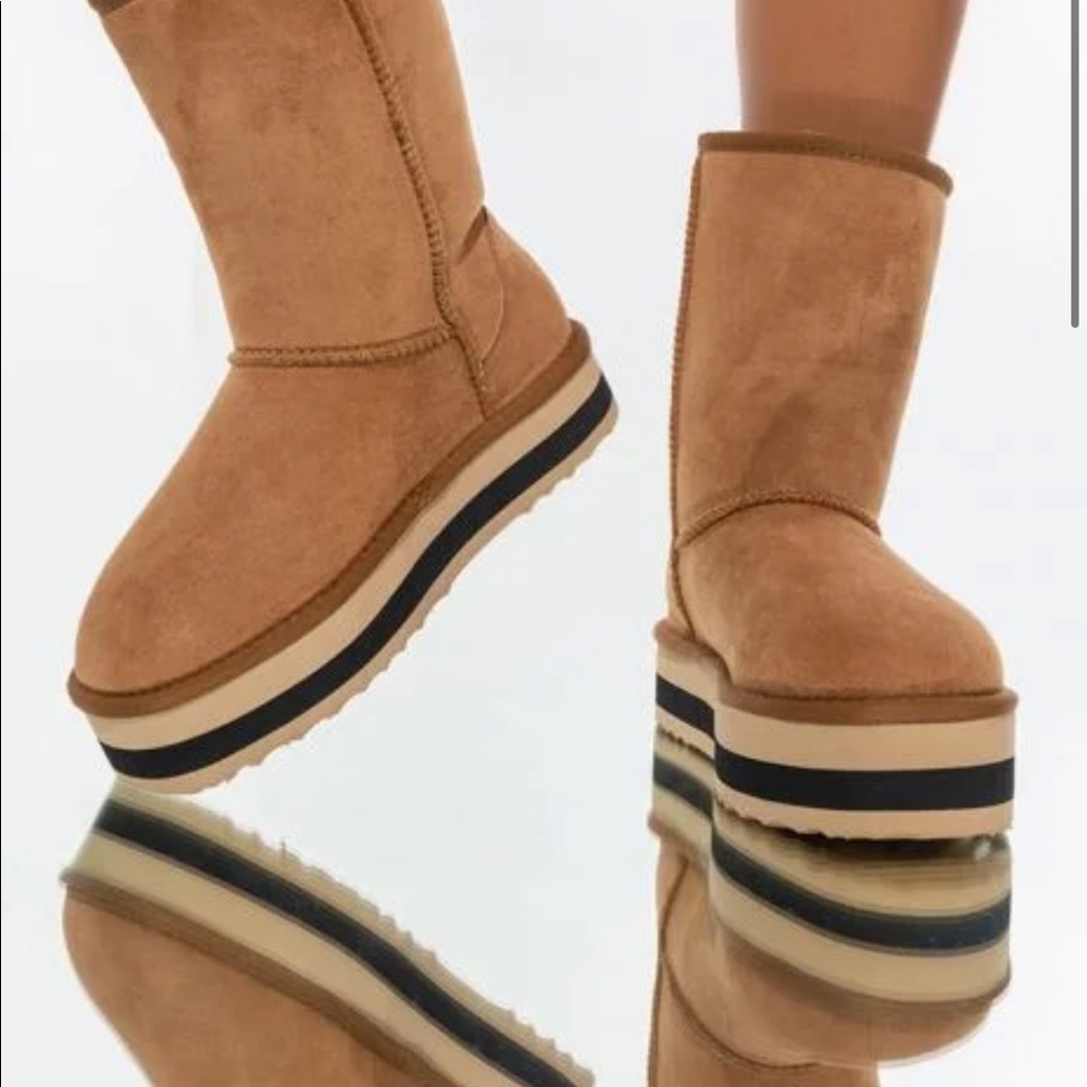 Features a faux suede upper mid calf rounded toe platform sole faux fur lining.